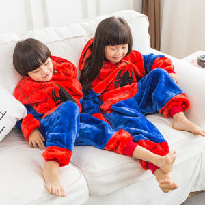 Due bambini sul divano con il set di pigiama blu e rosso di Spiderman
